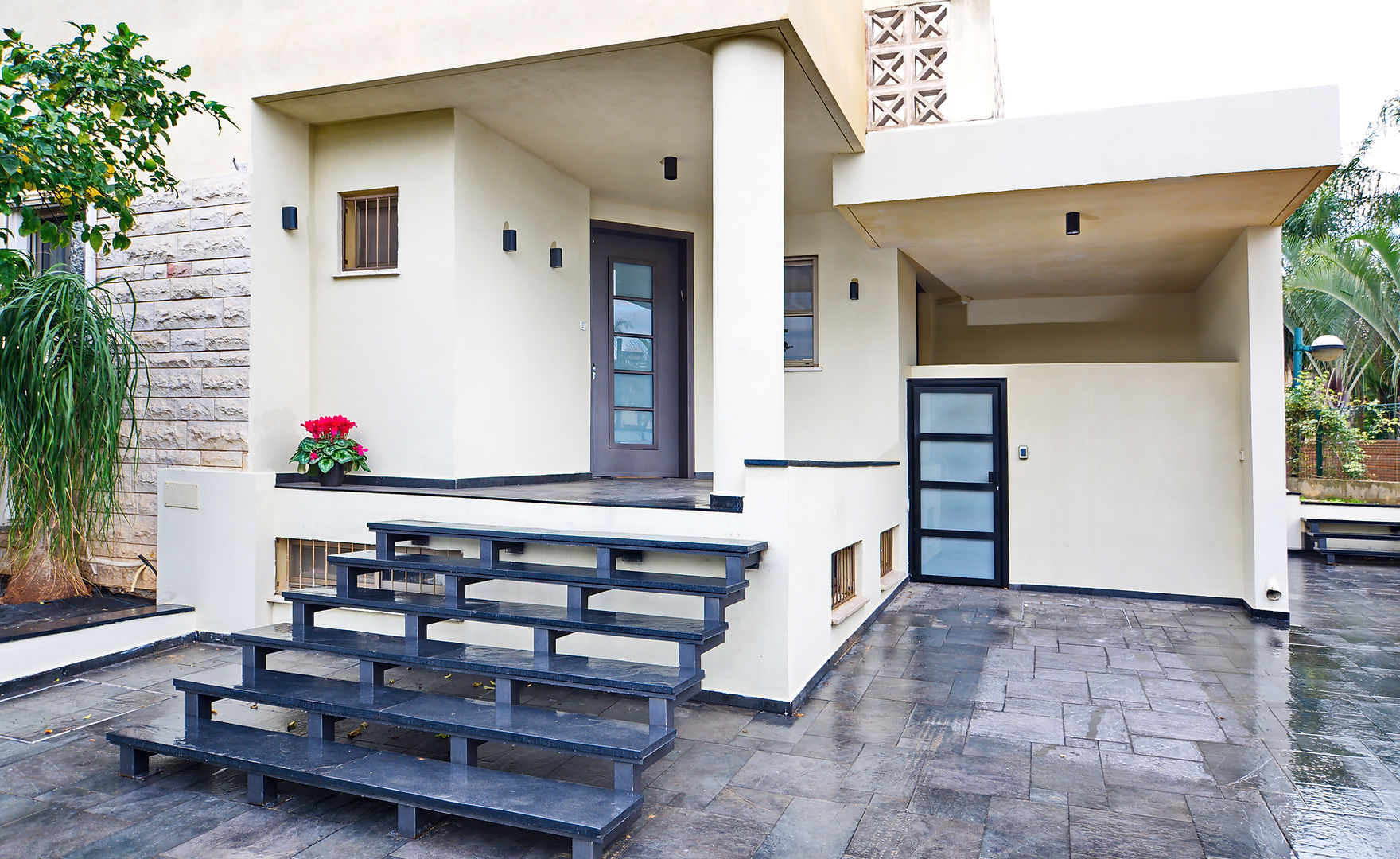 Modern renovated home exterior with stone steps and contemporary architecture